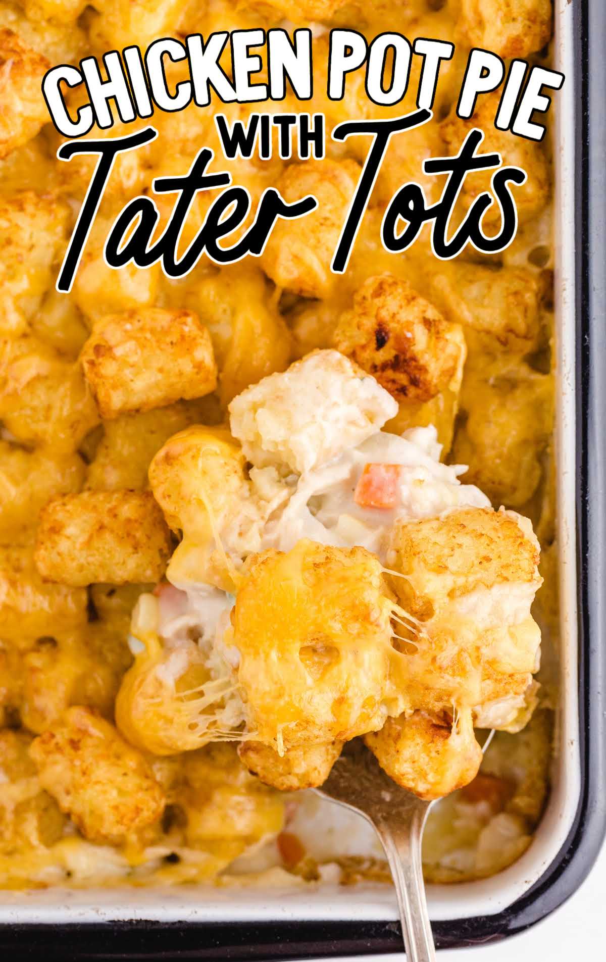 close up overhead shot of chicken pot pie with tater tots being picked up with a spoon from a baking dish