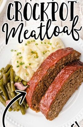 close up overhead shot of slices of crockpot meatloaf served on a plate with mashed potatoes and green beans