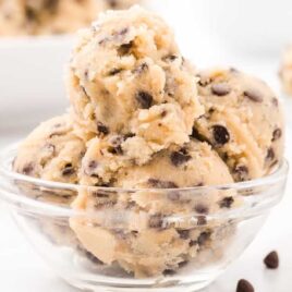 close up shot of scoops of edible cookie dough in a bowl with a fork
