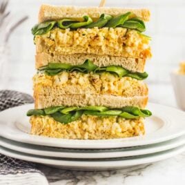 Egg Salad Sandwich stacked on top of each other on a plate