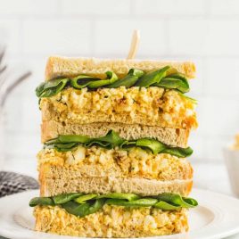 Egg Salad Sandwiches stacked on top of each other on a plate