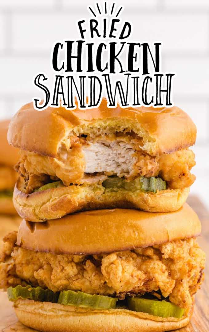 close up shot of fried chicken sandwich stacked on top of each other on a wooden board