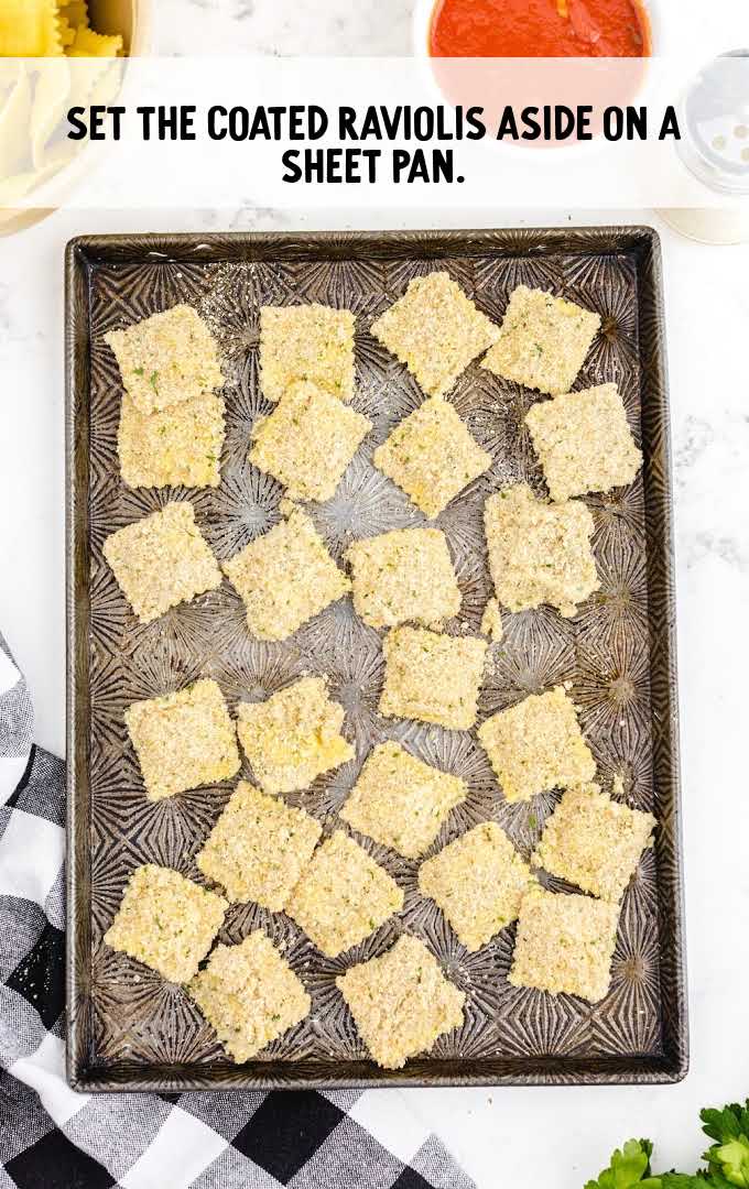 fried ravioli process shot of raviolis on a sheet pan