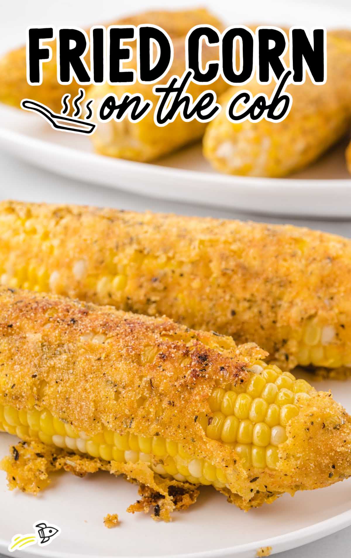 Side view of two pieces of fried corn on the cob, crispy and seasoned
