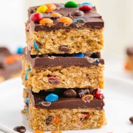 close up shot of No Bake Monster Cookies stacked on top of each other on a plate