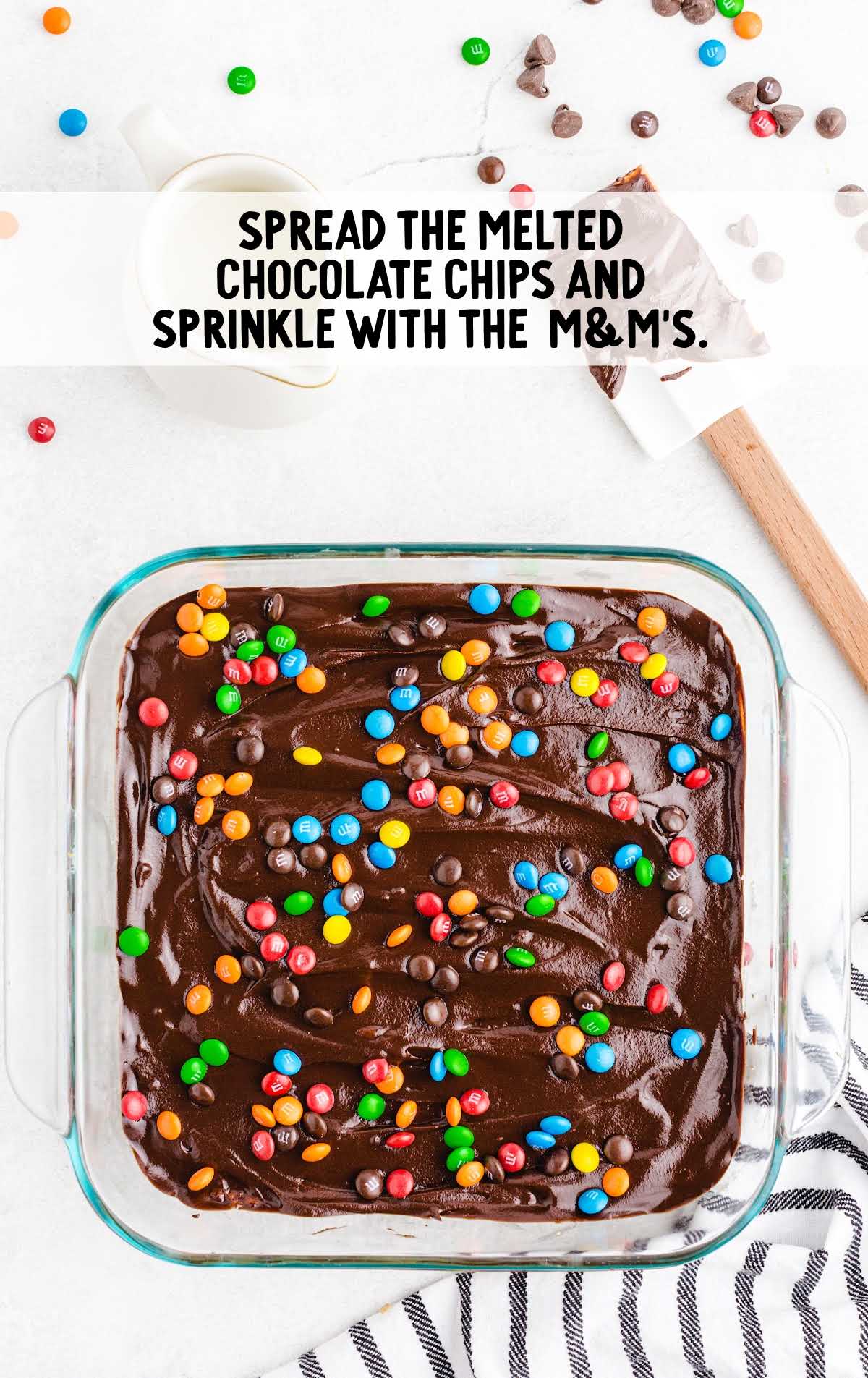 melted chocolate spread and m&m's sprinkled in a pan