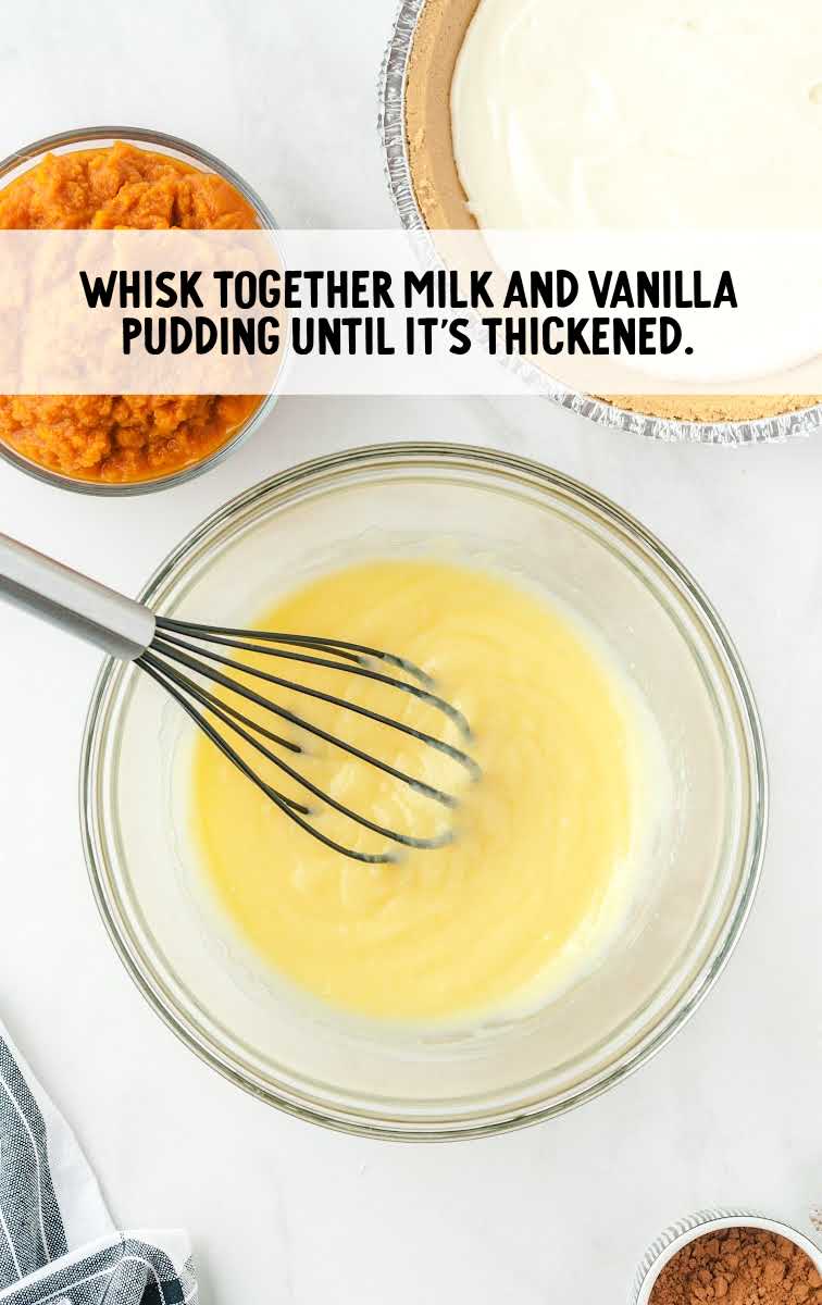 milk and vanilla pudding being whisked together in a bowl
