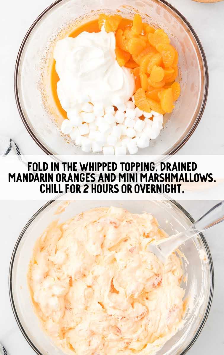 whipped topping, mandarin oranges, and mini marshmallows combined in a bowl