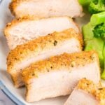 close up shot of Parmesan Pork Chops served with broccoli on a plate