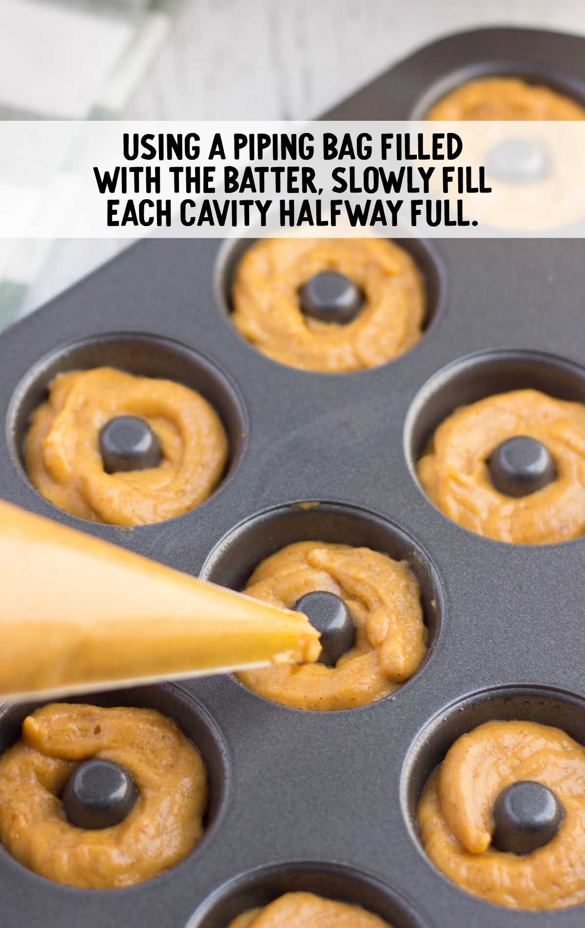 donut pan being filled with batter