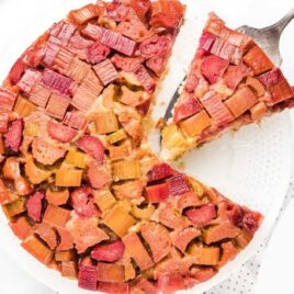 close up overhead shot of Rhubarb Upside Down Cake with a slice being taken out of it
