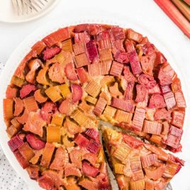 close up overhead shot of Rhubarb Upside Down Cake with a slice being taken out of it