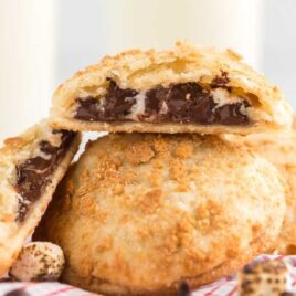 close up shot of a S'mores Hand Pies cut in half showing it's inside chocolate layers