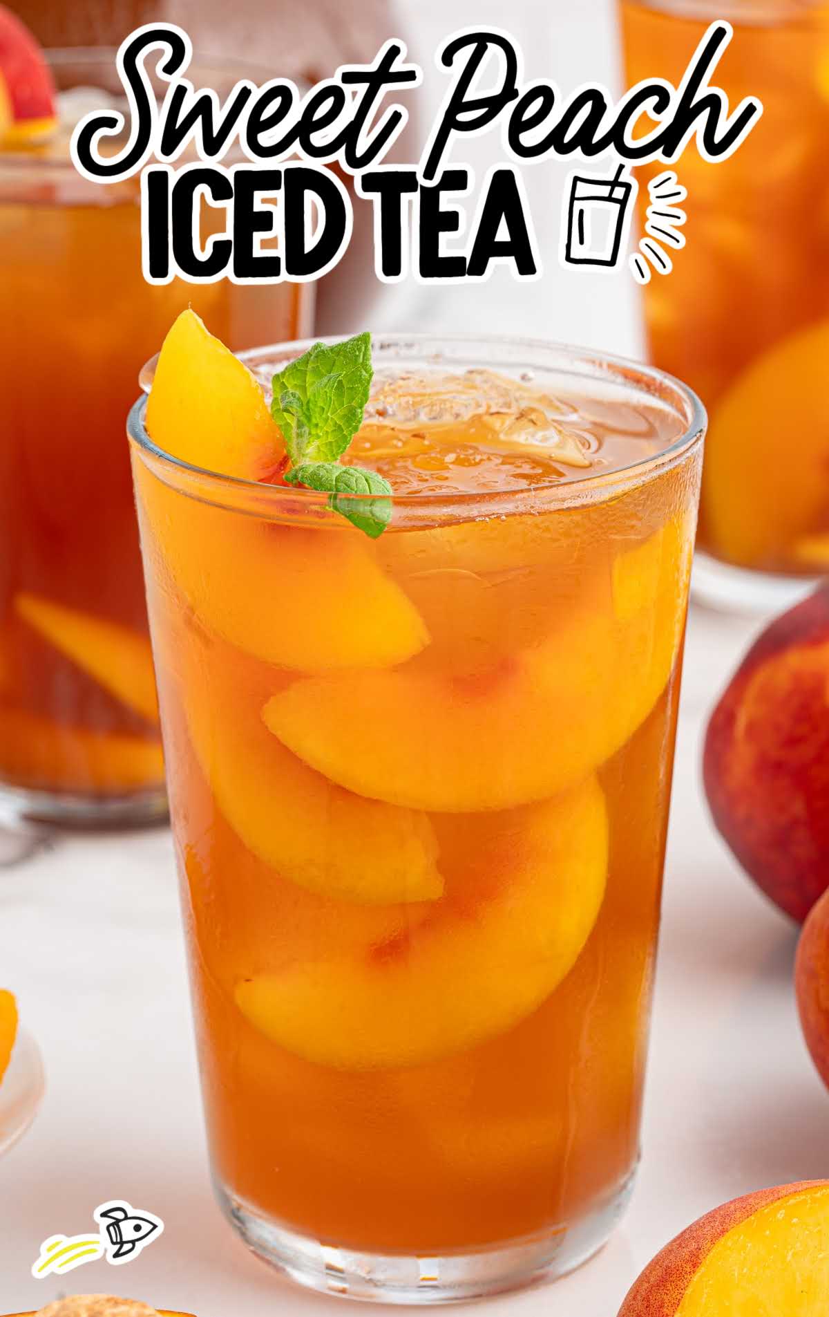 Tall glass of sweet peach iced tea with peach slices and mint, labeled “Sweet Peach Iced Tea” in bold text.