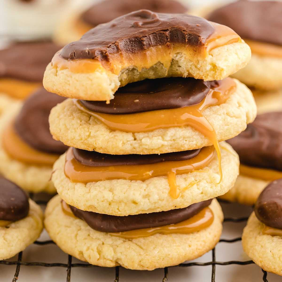 close up shot of a bunch of cookies stacked on top of each other on a cooling rack