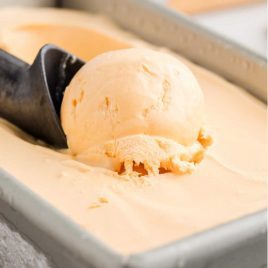 close up shot of cheese ice cream being scooped up with a ice cream scooper