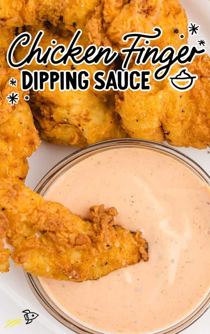 close up overshot of chicken finger dipping sauce in a bowl with a chicken tender being dipped into it