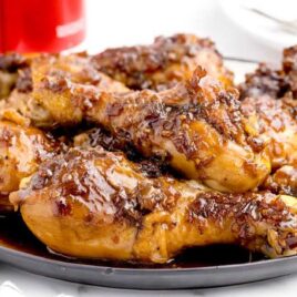 close up shot of coca-cola chicken on a plate