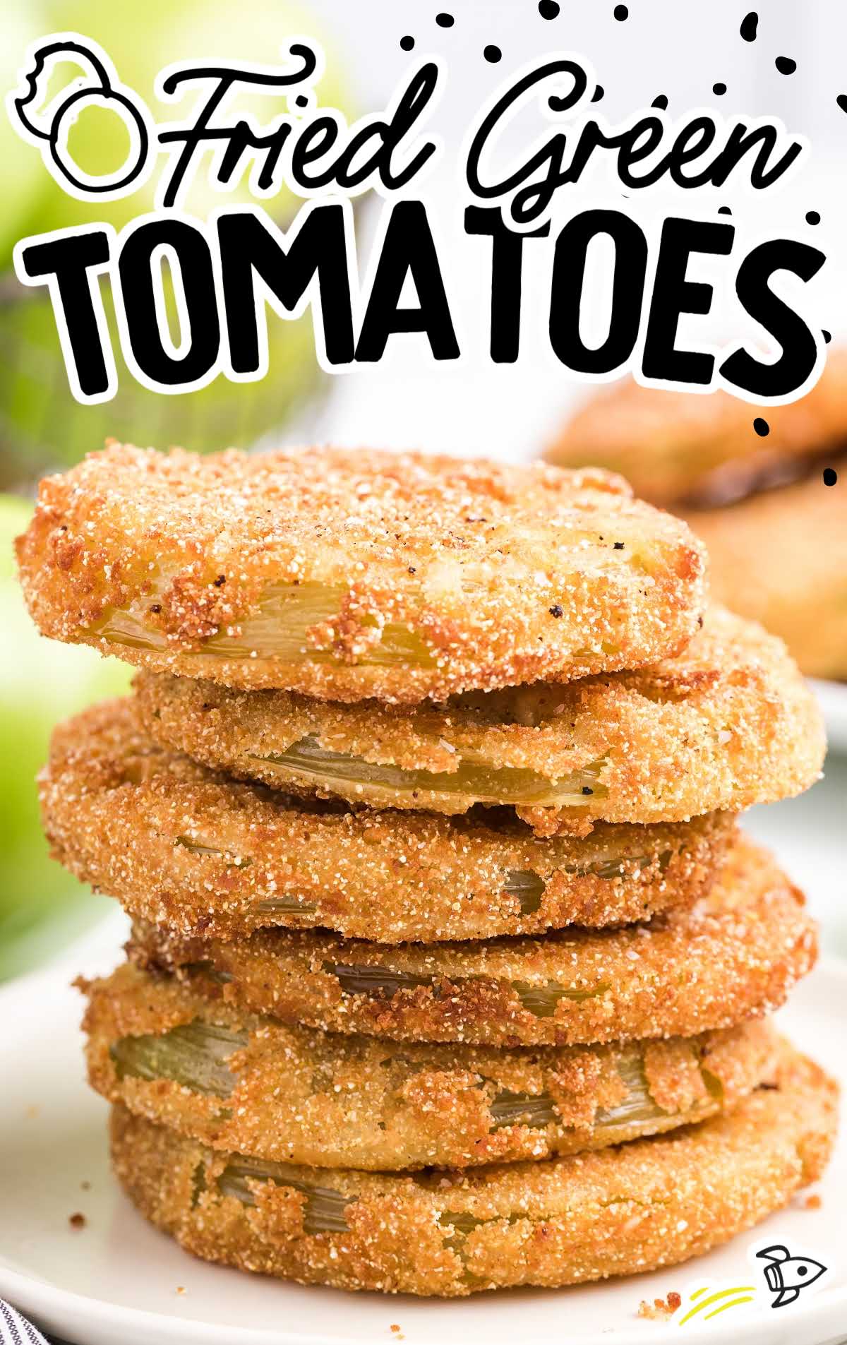 close up shot of fried green tomatoes stacked on top of each other on a plate