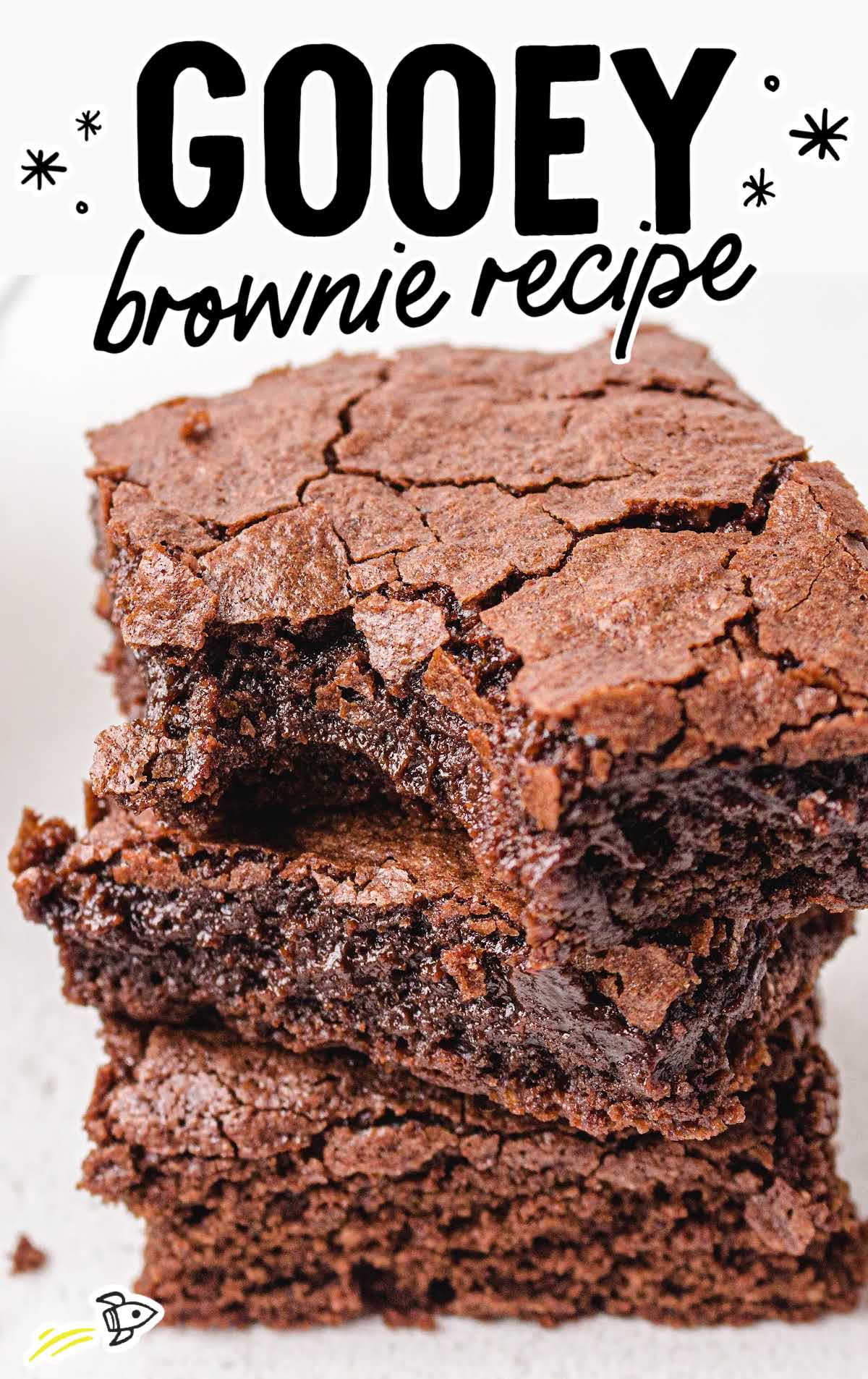 Ultra gooey egg white brownies stacked to show their chewy texture and soft chocolate center