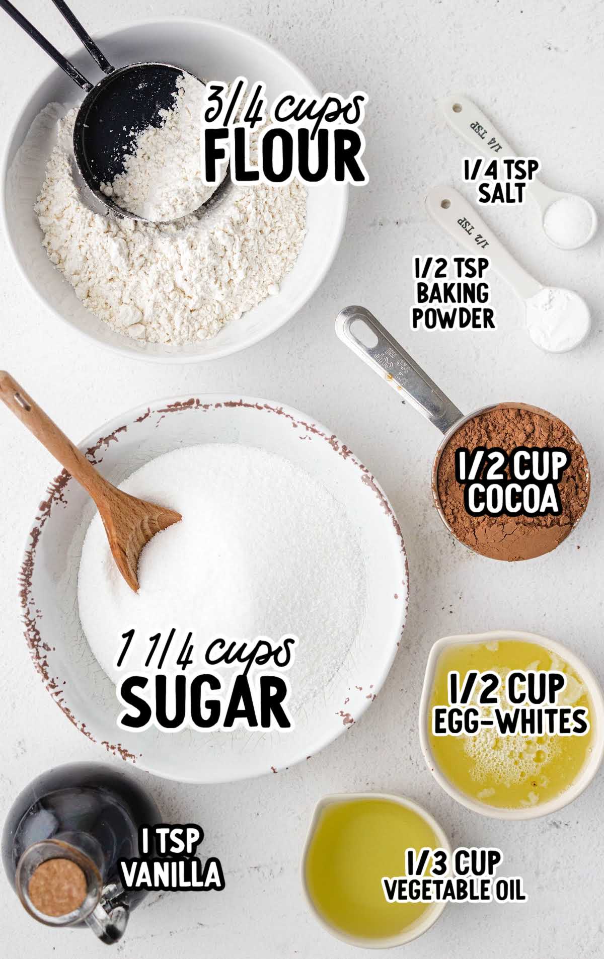 Ingredients for egg white brownies including flour, cocoa powder, sugar, egg whites, oil, vanilla, baking powder, and salt