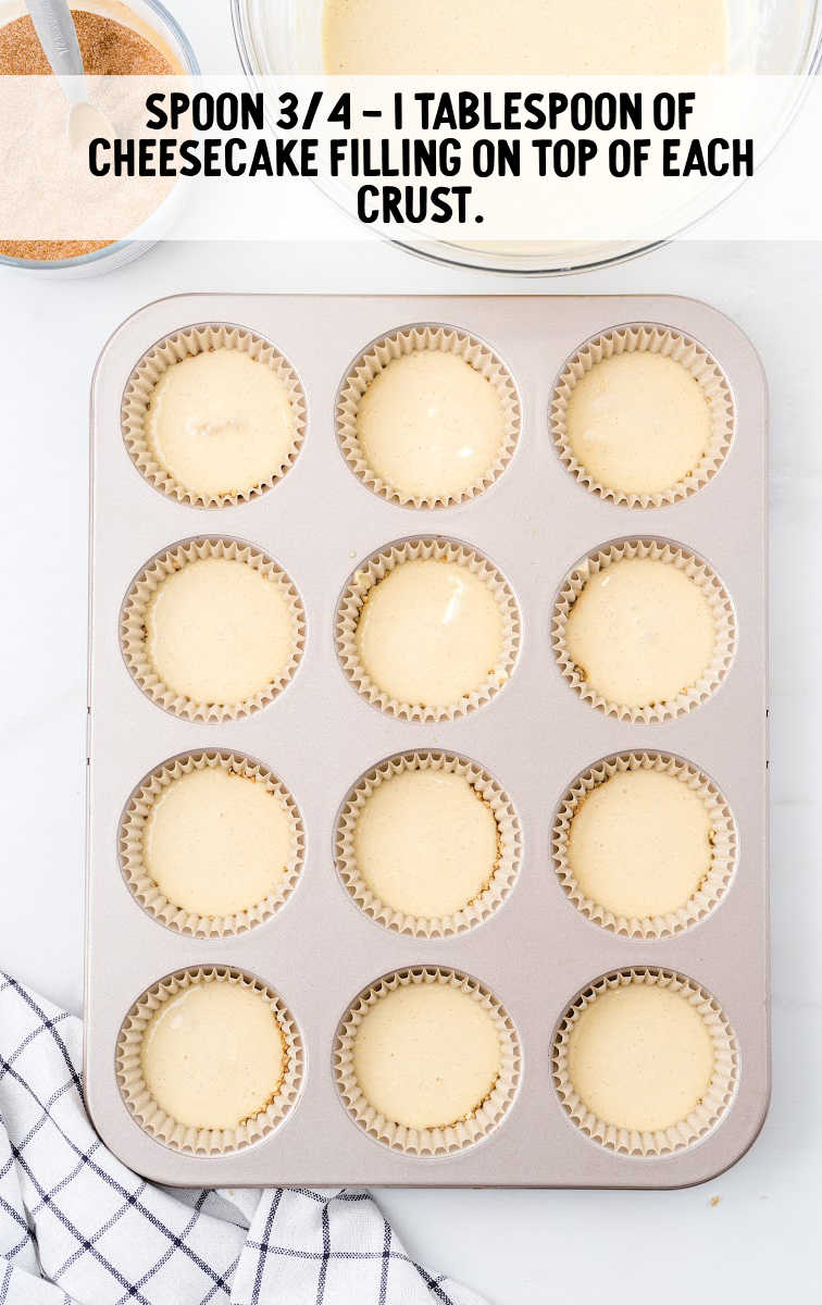 mini cinnamon roll cheesecakes process shot of cheesecake filling spooned in cupcake pans
