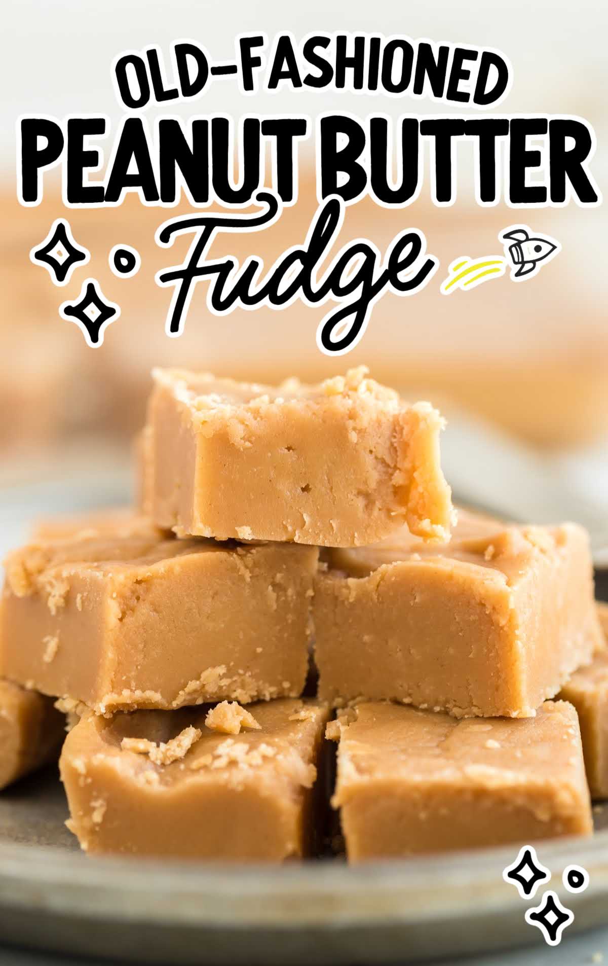a close up shot of pieces of Old Fashioned Peanut Butter Fudge stacked on top of each other on a plate