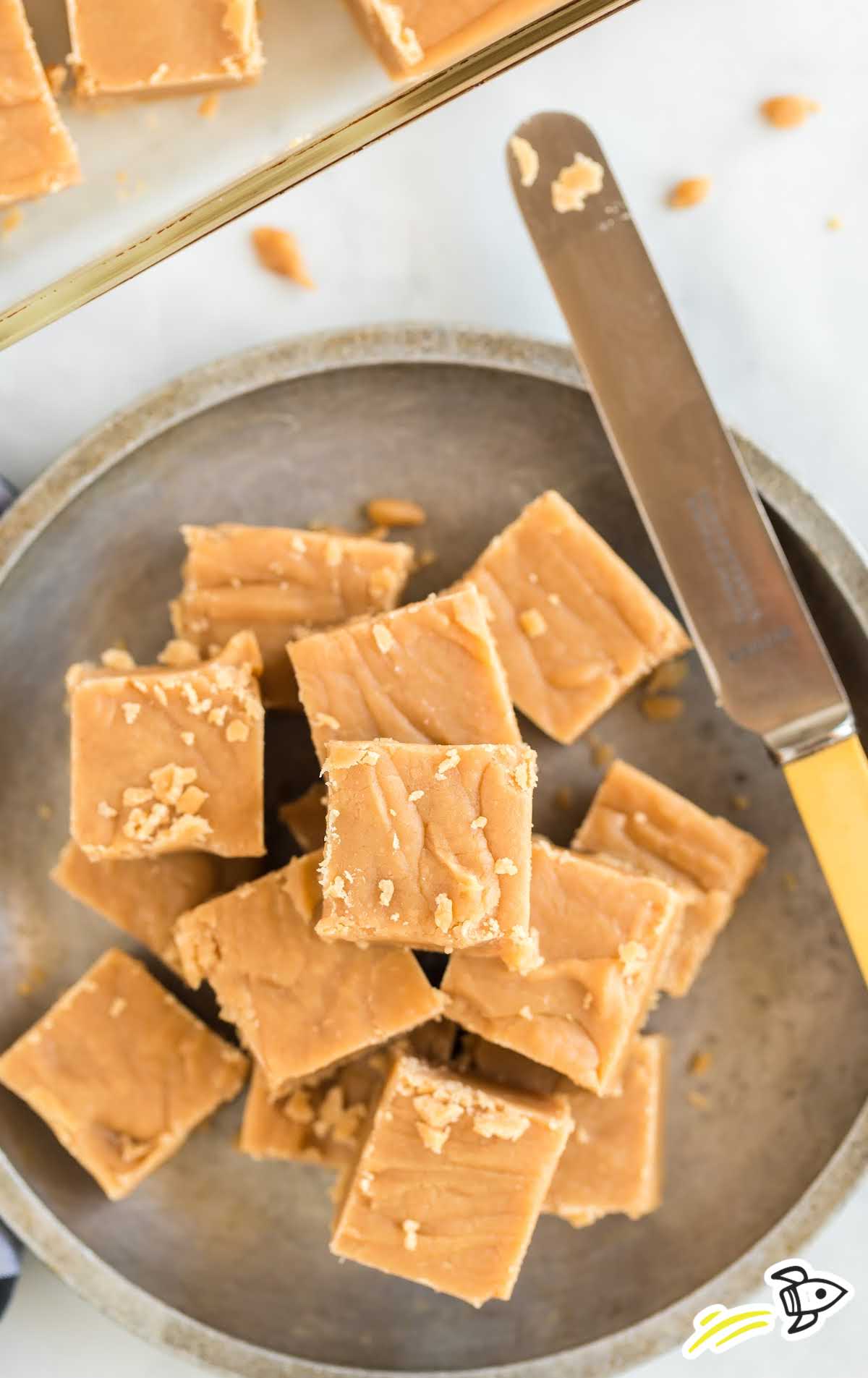 overhead shot of pieces of Old Fashioned Peanut Butter Fudge stacked on top of each other on a plate