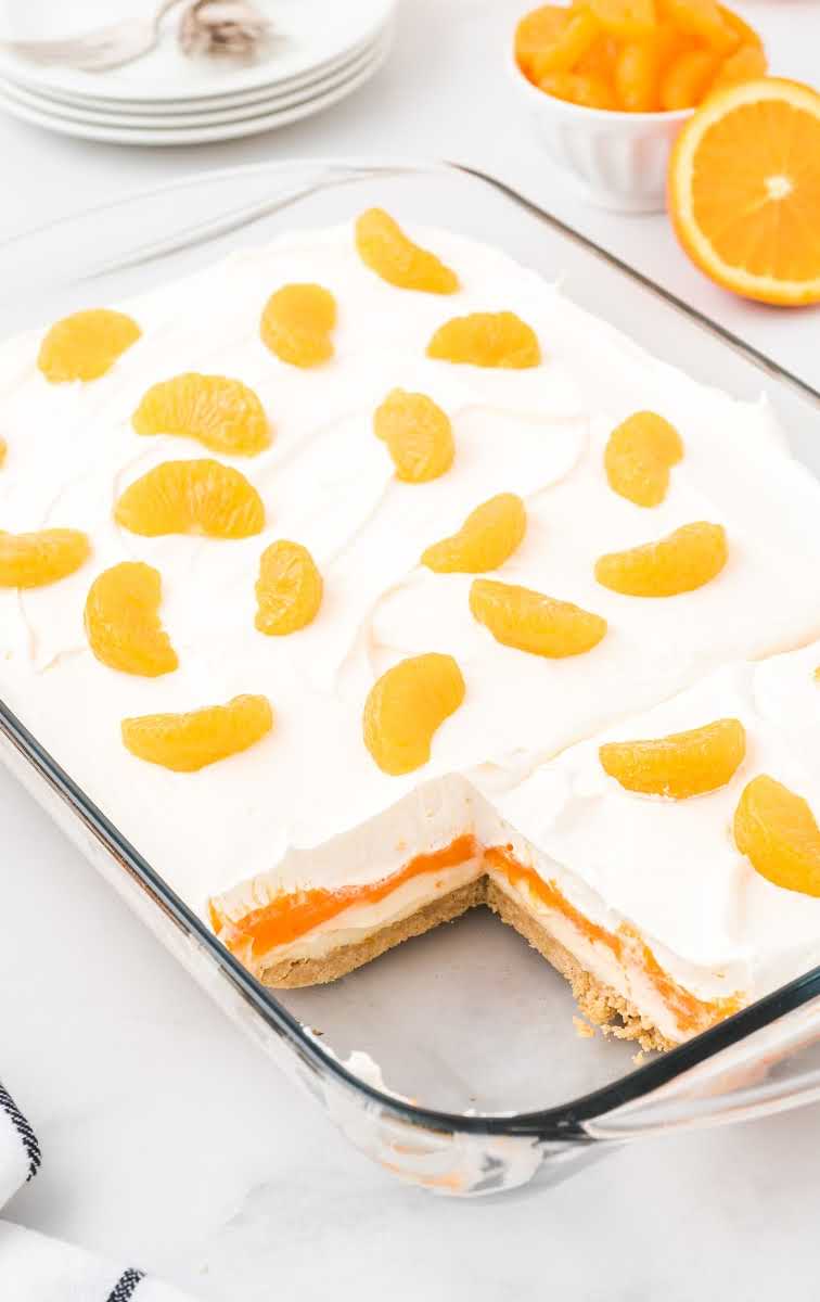 close up shot of Orange Creamsicle Lush topped with mandarin oranges in a baking dish