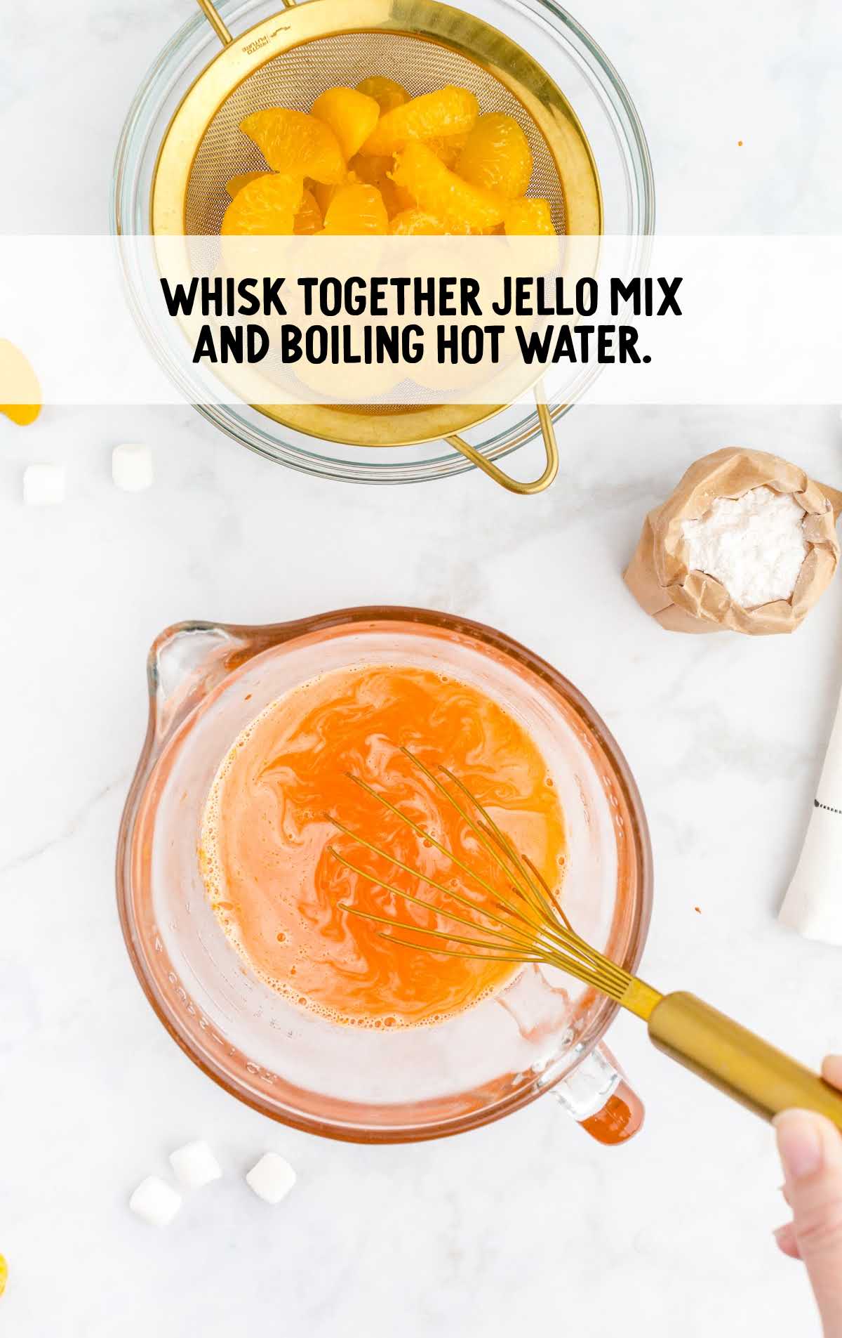 jello mix and boiling water whisked together in a cup