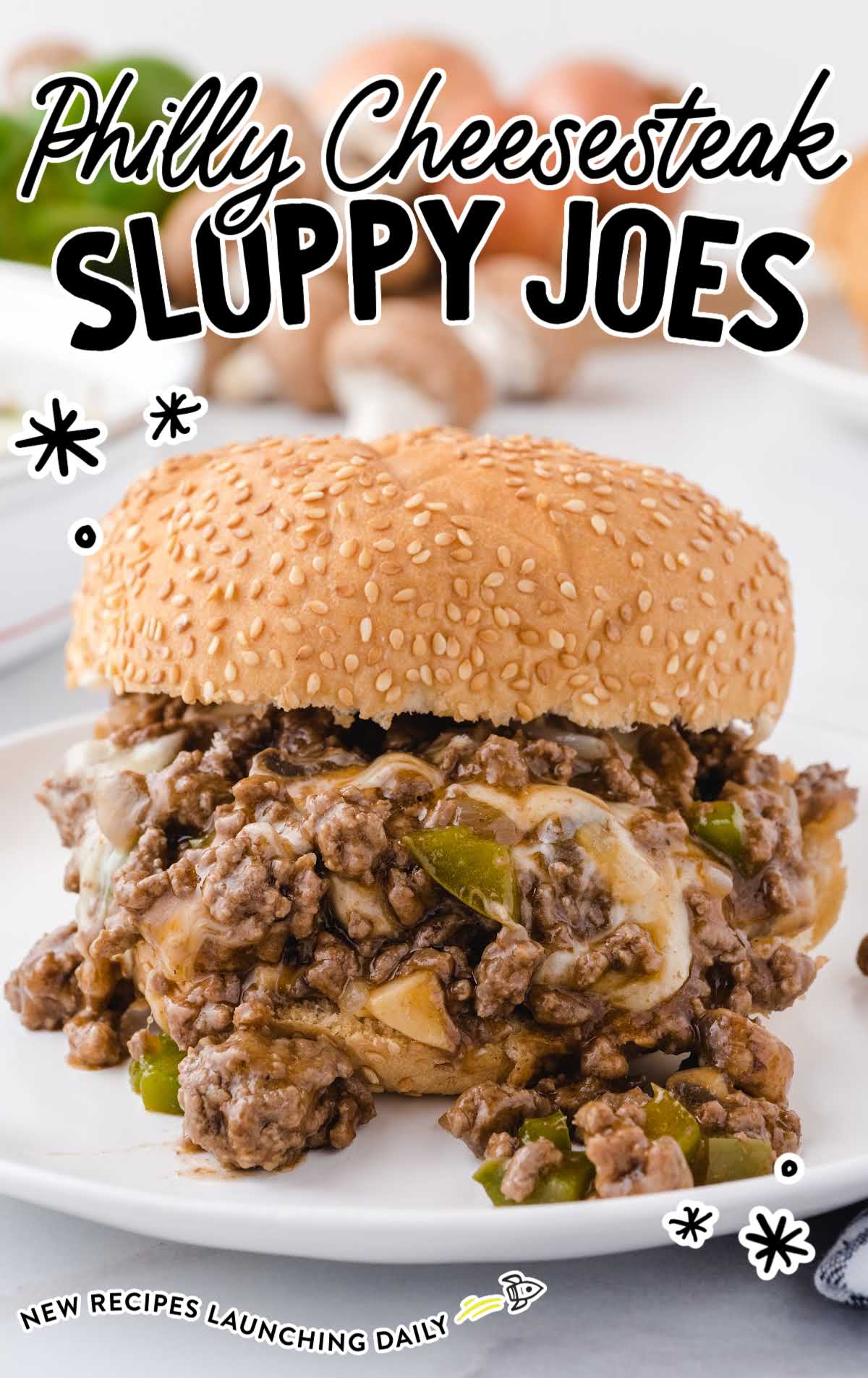 close up shot of philly cheesesteak sloppy joes with provolone and green peppers on buns