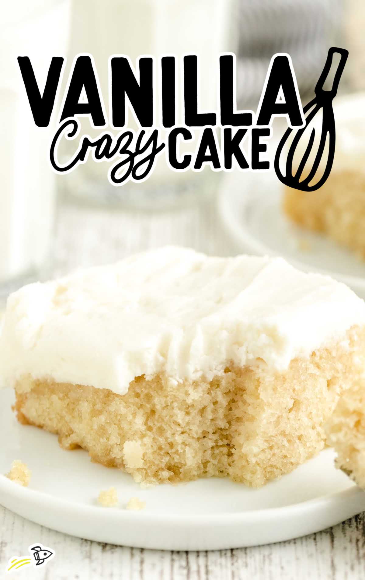Slice of vanilla crazy cake with fluffy white frosting, styled for a vertical hero image with text overlay reading "Vanilla Crazy Cake."