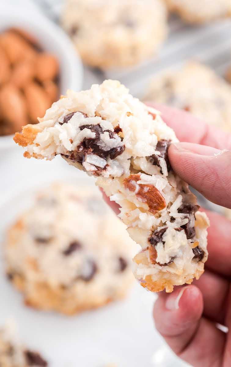 close up shot of Almond Joy Cookies with a bite taken out of it