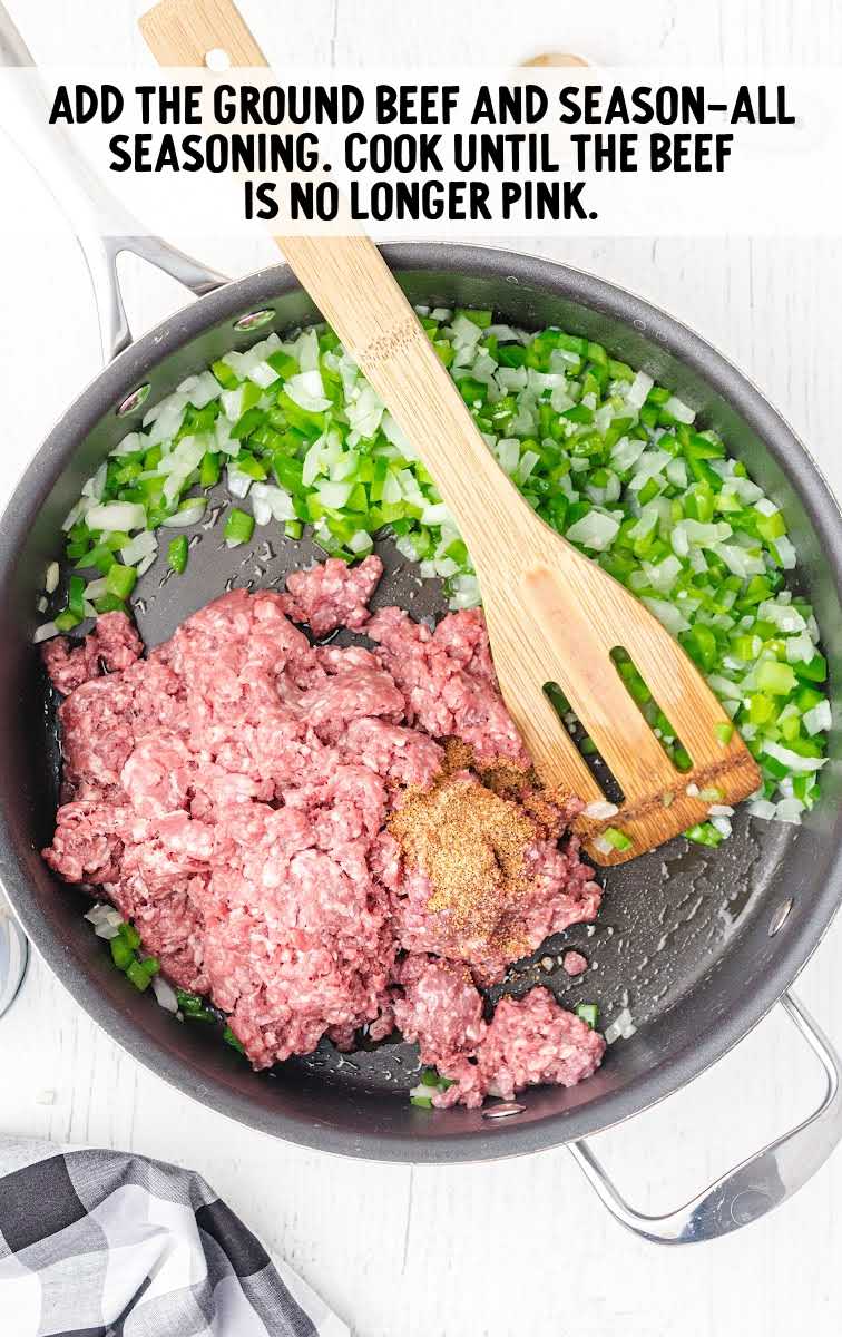 amish casserole process shot of ground beef topped with seasonings in a skillet