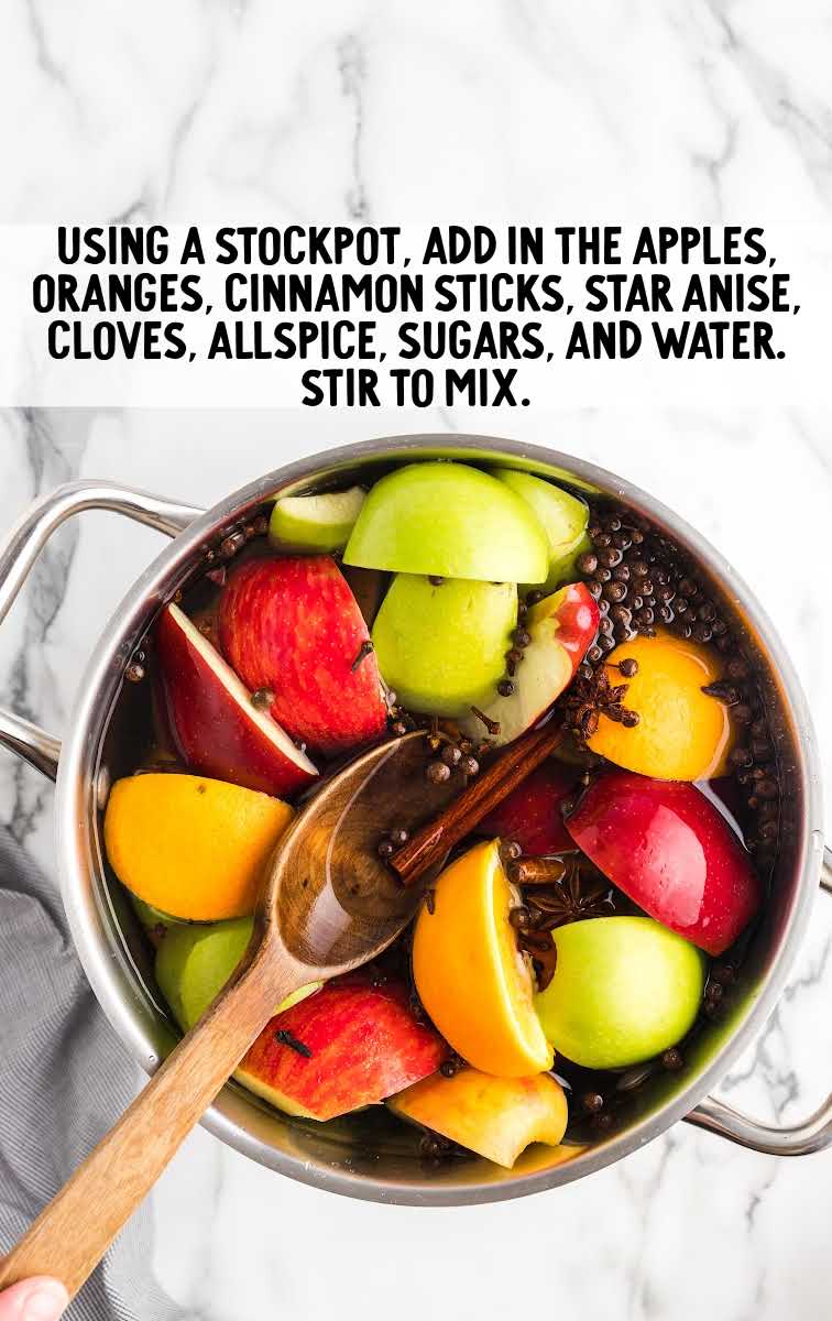 apples, oranges, cinnamon sticks, star anise, cloves, allspice, sugar, and water stirred together