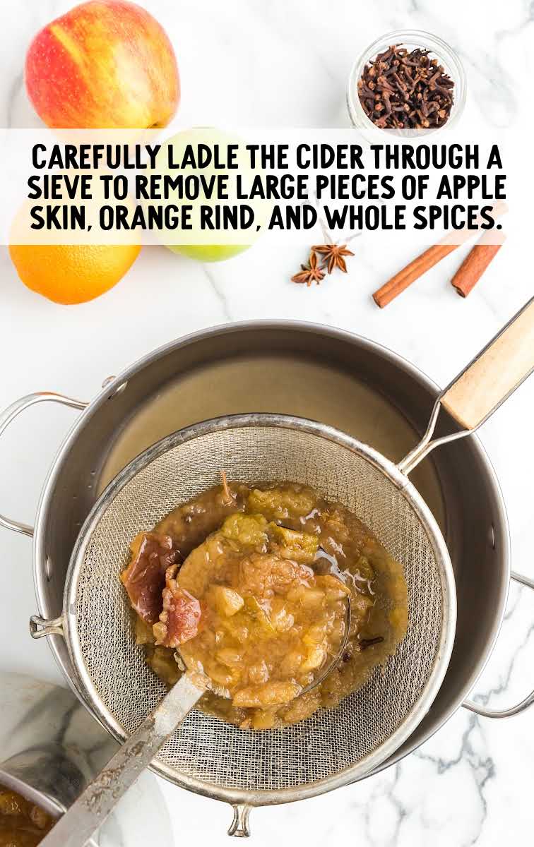 Apple Cider process shot of ingredients being drained from the stockpot