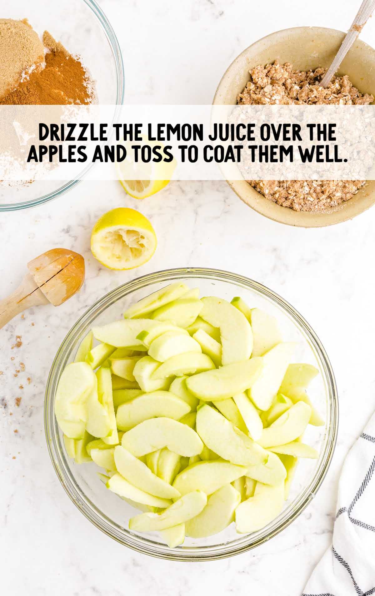 lemon juice drizzled over apples in a bowl