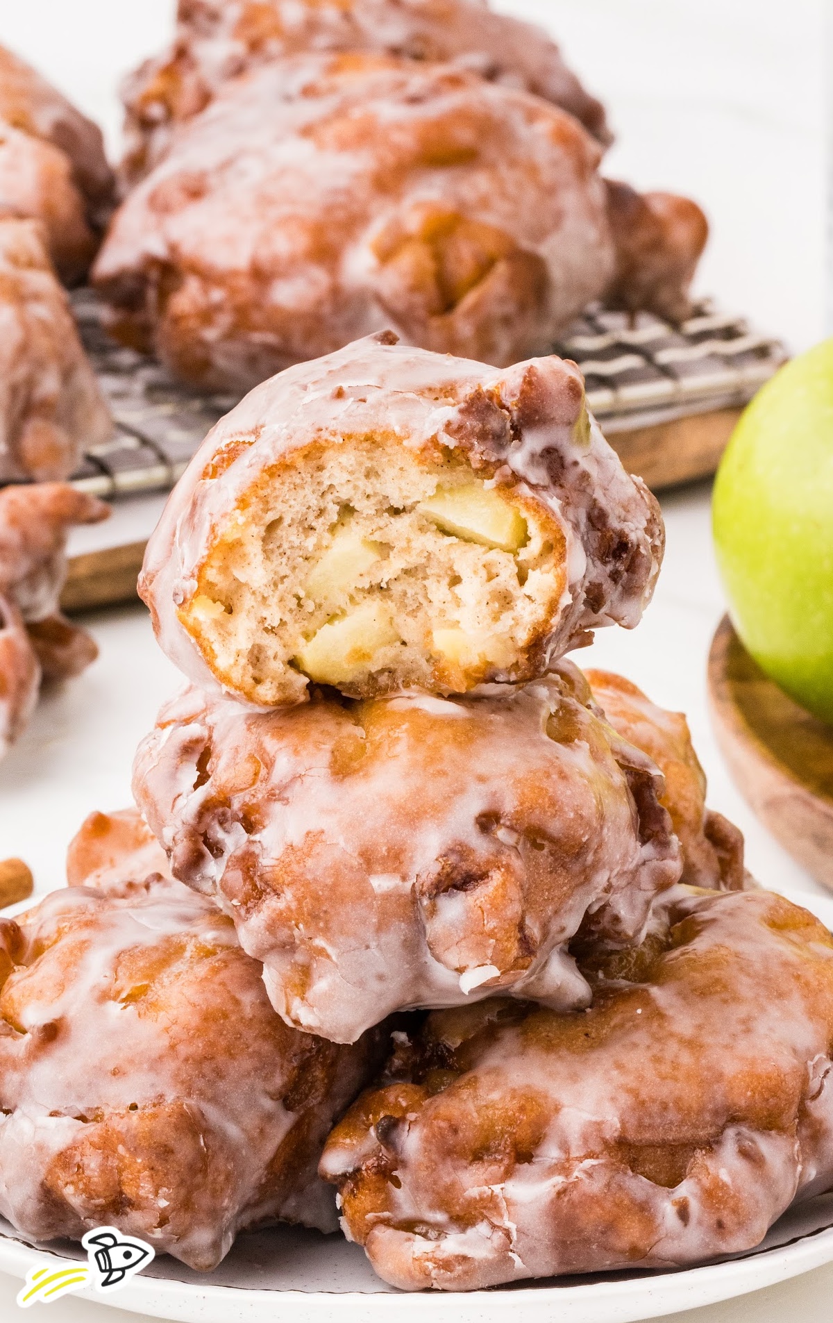 A close up of food on a plate, with Apple and Fritter