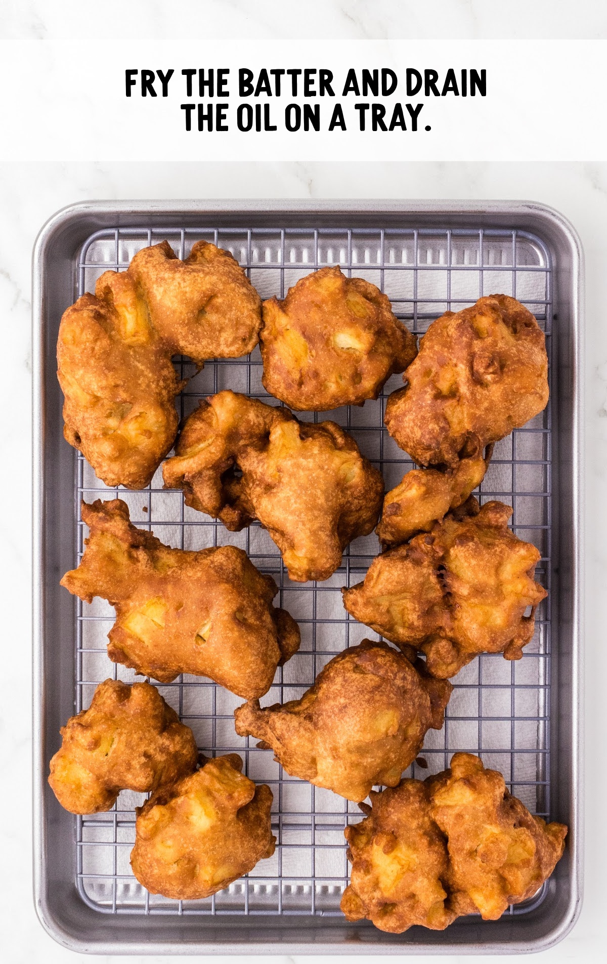 A close up of food on a grill, with Apple and Fritter