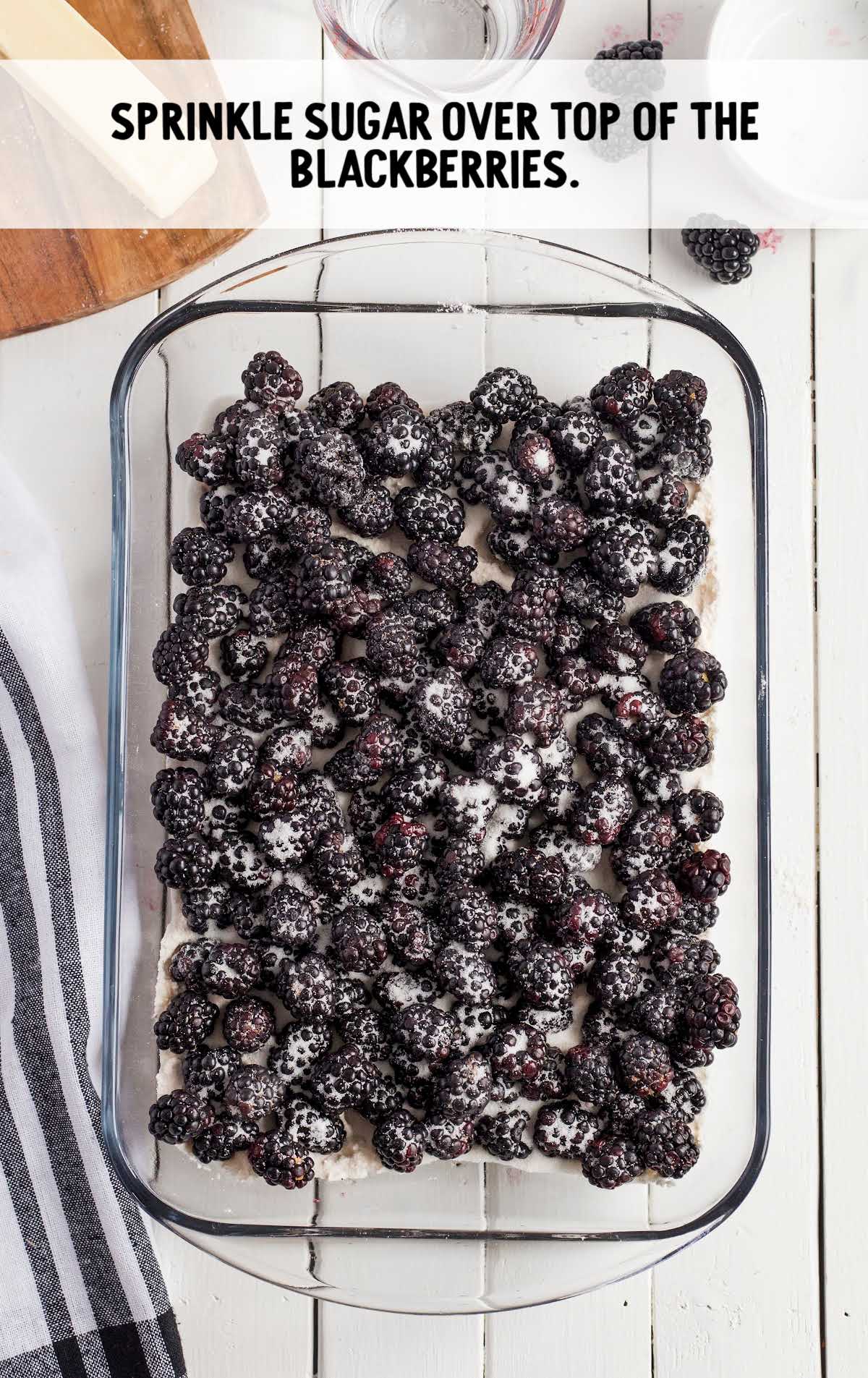 blackberries with sugar sprinkled on top in a baking dish
