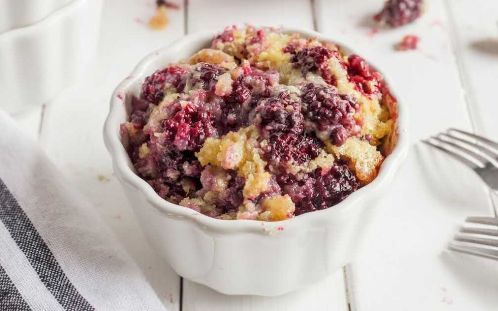 a serving of blackberry cobbler in a white bowl