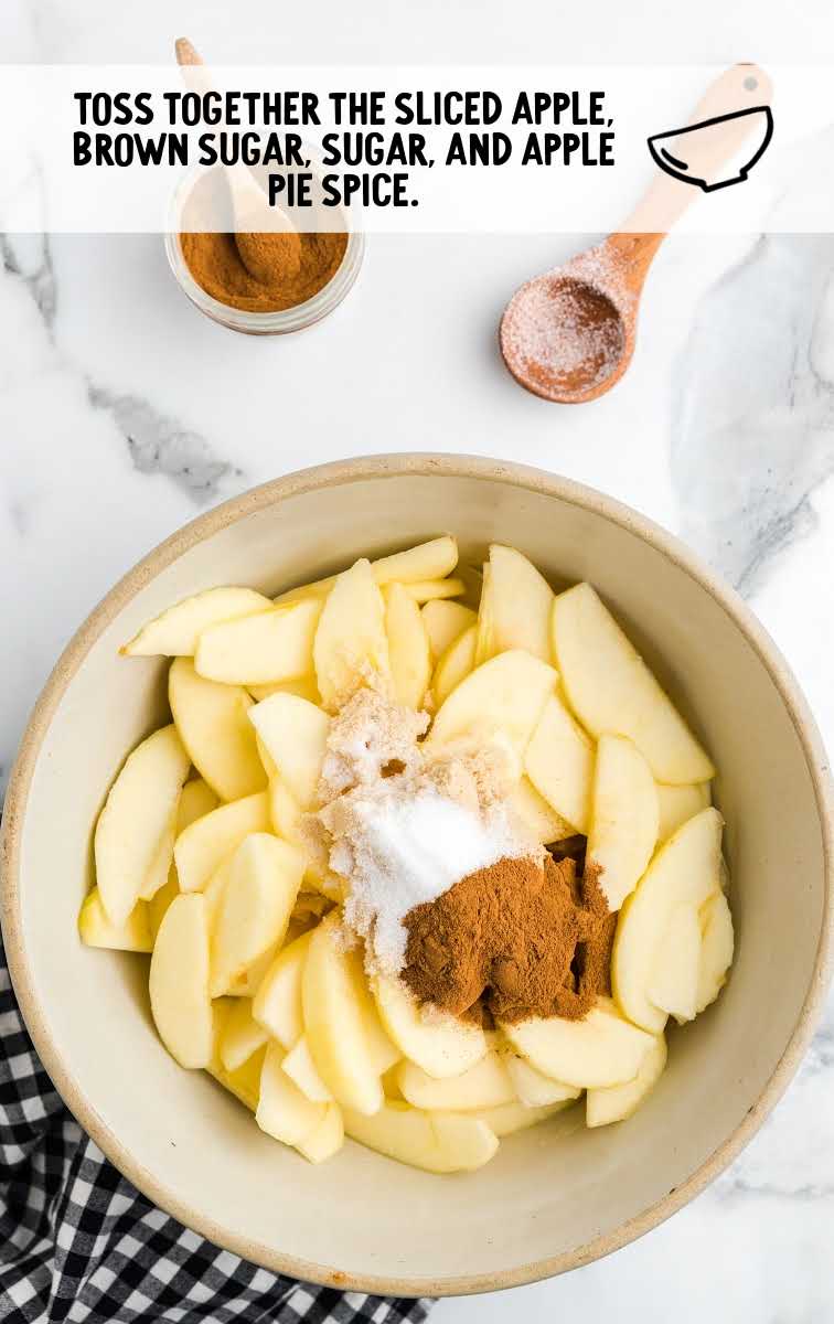 sliced apples, brown sugar, sugar, and apple pie spice tossed together 
