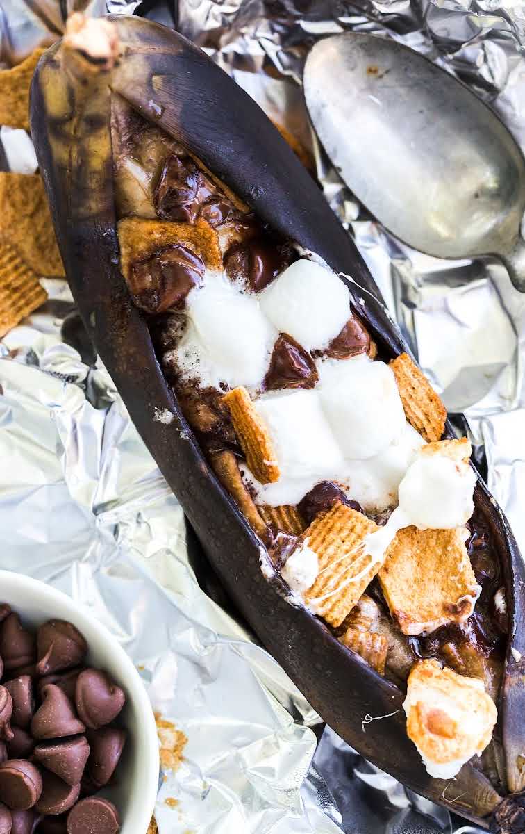 close up shot of campfire banana boats with a spoon on aluminum foil