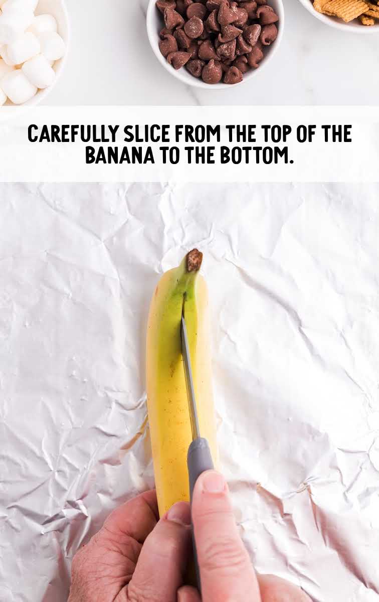 banana being sliced open with a knife