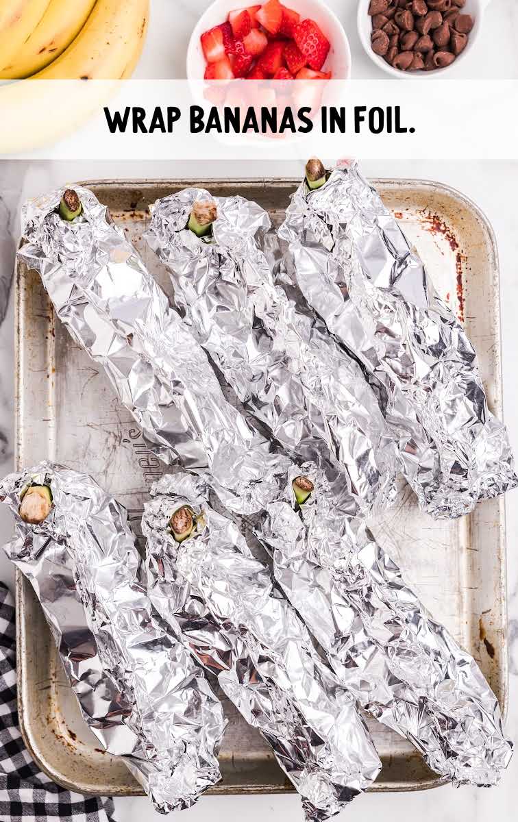 banana being wrapped in aluminum foil