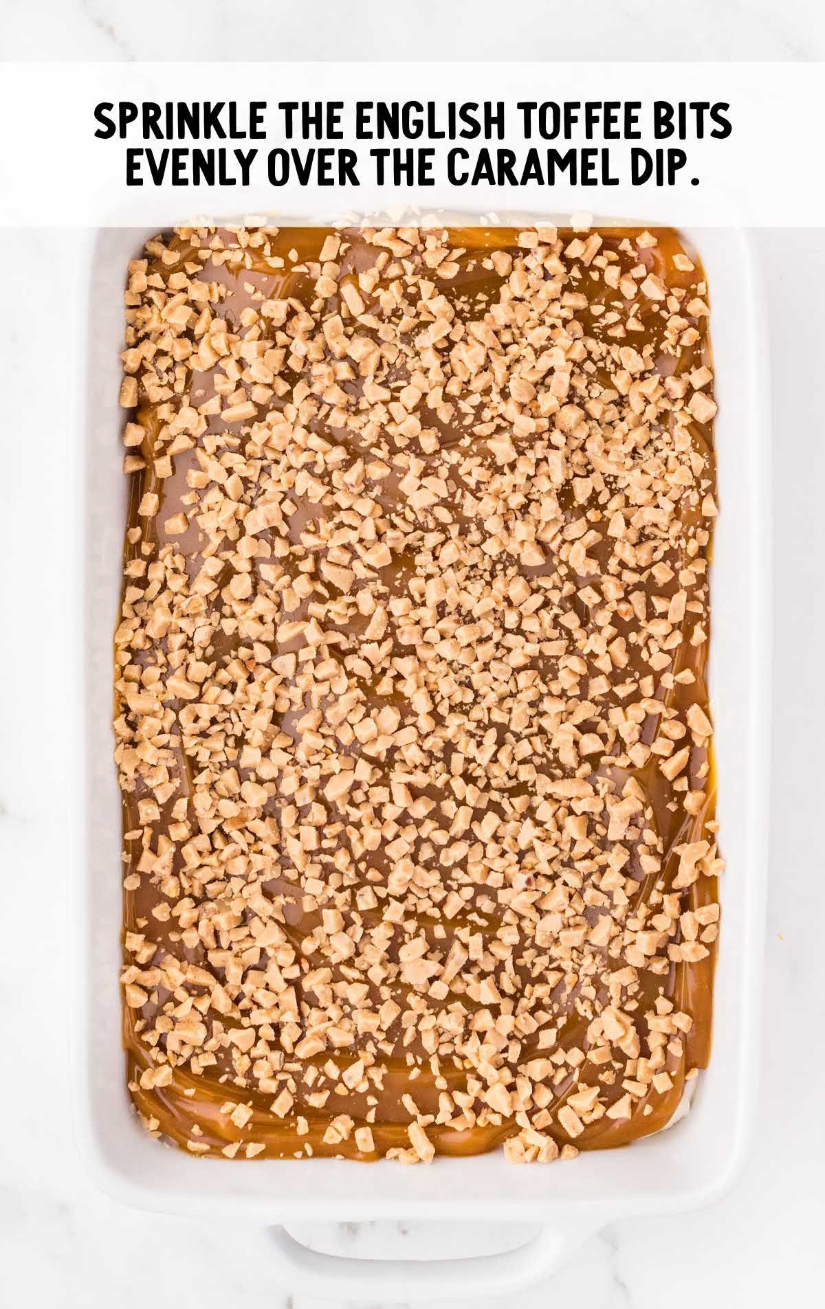 English toffee bits sprinkled over the caramel apple dip