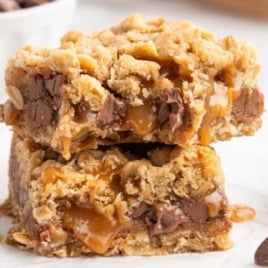 Two stacked Carmelitas bars with melty caramel and chocolate layers.