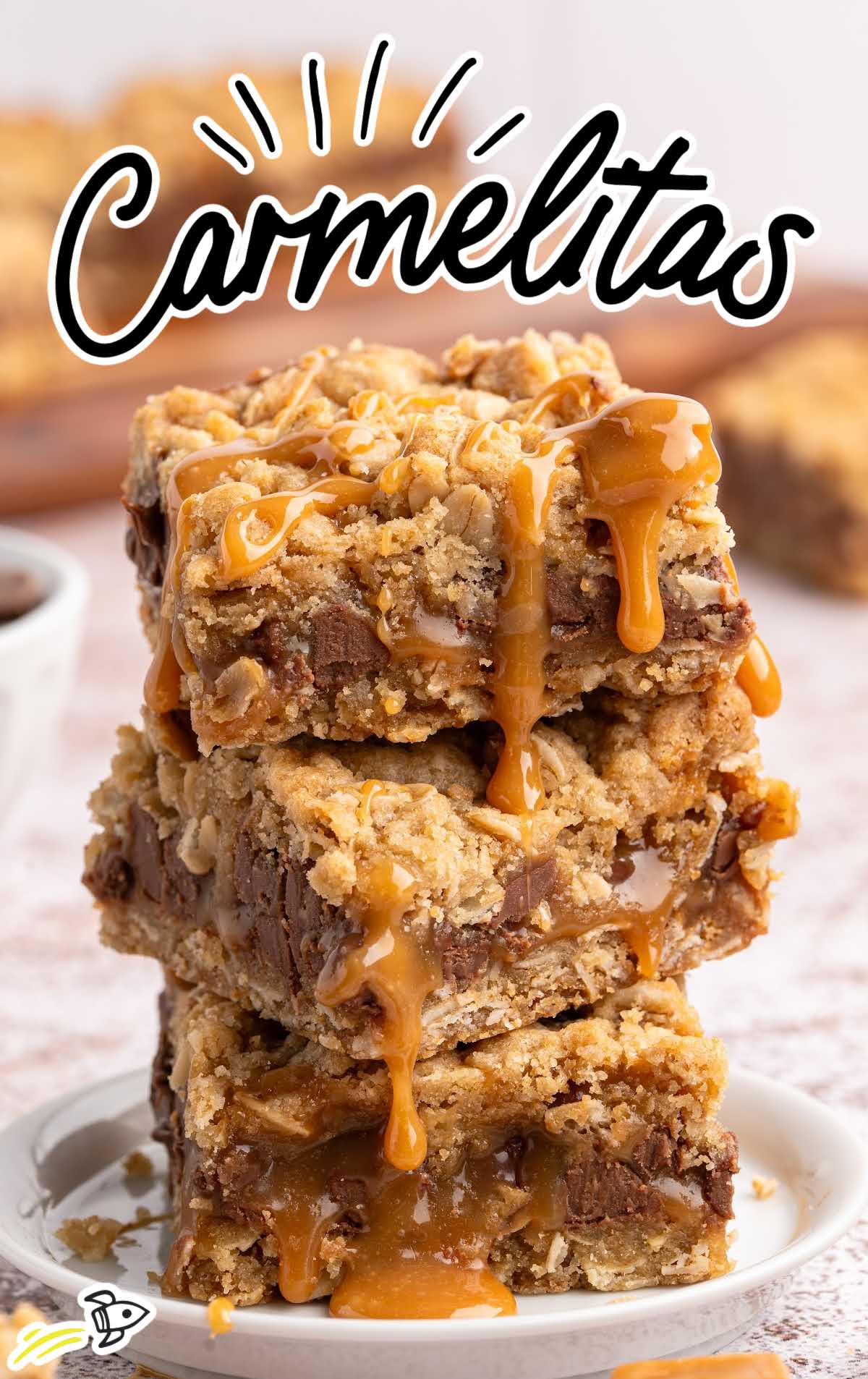 Stack of gooey caramel-filled Carmelitas bars on a plate with caramel dripping down.