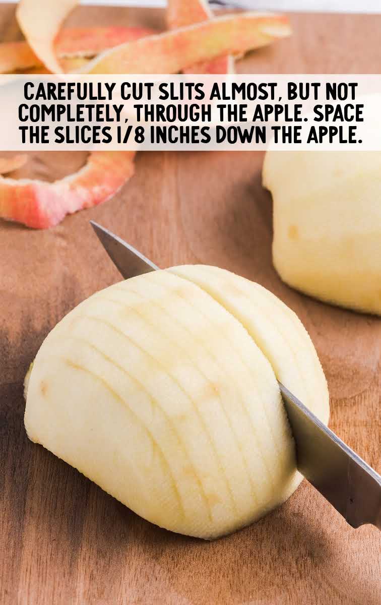 slits being cut into apple on a wooden board