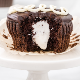 A piece of chocolate cake on a plate, with Cupcake